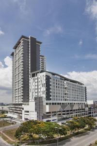 a large tall building with a road in front of it at Citadines DPulze Cyberjaya in Cyberjaya