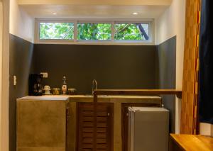 a small kitchen with a sink and a window at Afreeka Beach Hotel in Las Terrenas