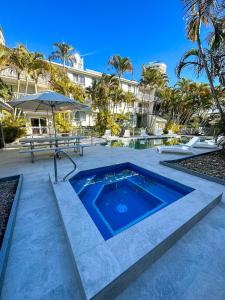 a swimming pool in the middle of a patio at Bay Lodge Apartments in Gold Coast