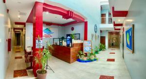 a lobby with a pharmacy with plants in it at RedDoorz at Gracia's Calzada Inn Camiguin in Mambajao