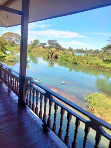 a view of a river from a balcony at Riverside Bungalow Don Det in Don Det