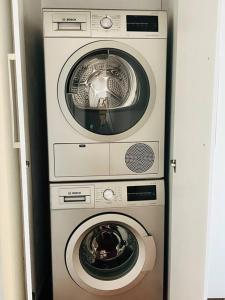 two washing machines and a washer in a room at 2 Bedroom, Clutter free in Pretoria