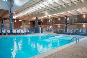 a large swimming pool with blue water in a building at Delta Hotels by Marriott Grand Rapids Airport in Grand Rapids