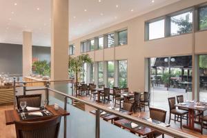 a restaurant with tables and chairs and windows at Sheraton Lagos Hotel in Lagos