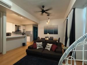 a living room with a couch and a ceiling fan at Love De Sea 4pax 850sf 2R2B Imperium Residence in Kuantan