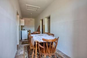 a kitchen with a table and chairs and a refrigerator at Apartments by the sea Tisno, Murter - 21405 in Tisno