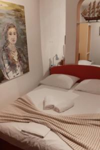 a bedroom with a bed with a painting on the wall at Apartments by the sea Podaca, Makarska - 19078 in Podaca