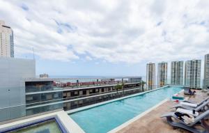 a swimming pool on top of a building with the beach at Boutique Apartments Panama Atlapa in Panama City