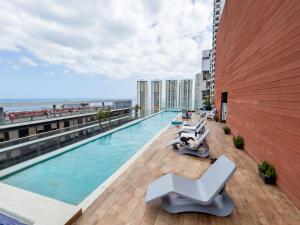 a swimming pool on the roof of a building at Boutique Apartments Panama Atlapa in Panama City