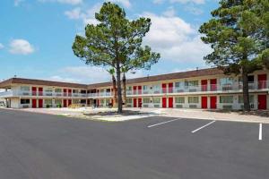 an empty parking lot in front of a building at Rodeo Inn in Pecos