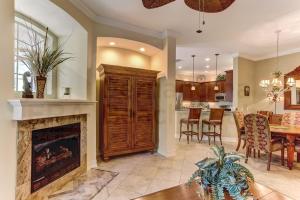 a living room with a fireplace and a dining room at Gated Villas at Summer Beach in Amelia Island