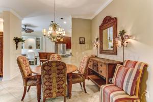 a dining room with a table and chairs and a mirror at Gated Villas at Summer Beach in Amelia Island