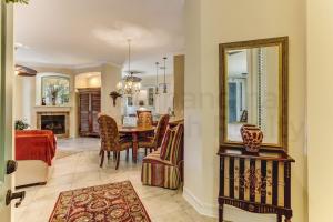 a dining room with a table and a mirror at Gated Villas at Summer Beach in Amelia Island