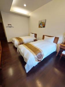 Postel nebo postele na pokoji v ubytování Xinhe Homestay