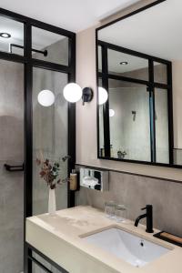 Un baño con lavabo y un espejo grande. en Parador de Ciudad Rodrigo, en Ciudad Rodrigo