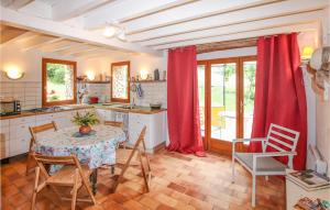 a kitchen with a table and chairs and red curtains at Gorgeous Home In Plan De Baix in Plan-de-Baix +6 photos