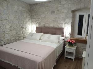 um quarto com uma cama e uma parede de pedra em Garma em Slatine