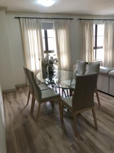 a dining room with a glass table and chairs at Superb Stay in Adelaides East End in Adelaide
