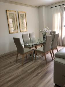 a dining room with a glass table and chairs at Superb Stay in Adelaides East End in Adelaide