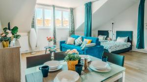 een woonkamer met een blauwe bank en een tafel bij Prague Retreat Apartment in Praag