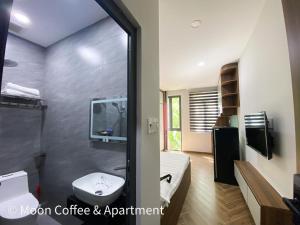 a bathroom with a shower and a toilet and a sink at Moon Apartment in Ho Chi Minh City +8 photos