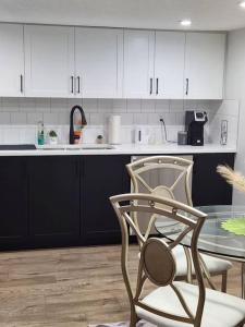 a kitchen with a table and a chair and a counter at 2-bedroom basement apartment in Calgary