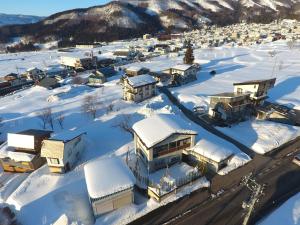 an aerial view of a town covered in snow at NIKONOS III in Nozawa Onsen