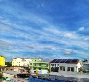 a group of buildings with a blue sky at Manh Phat Guesthouse - Nhà Nghỉ Mạnh Phát in Can Tho