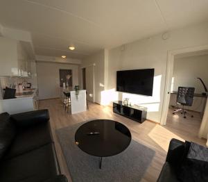 a living room with a couch and a table at Apartment in city center in Alta