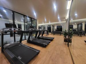 a gym with treadmills and a row of treadleys at MOST Family 456/66 Ubon-Thailand in Ubon Ratchathani