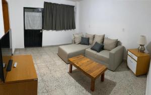a living room with a couch and a coffee table at Beds Friends Asis in Mexico City