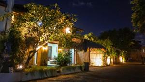 a house with lights on a street at night at KUTA - 4BR Villa with Private XL Pool in Kuta