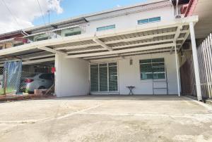 a garage with awning on the side of a building at 3 mins to Garden City & Kubota Jln Apas Homestay in Tawau