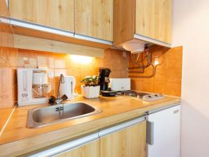 a kitchen with a sink and a counter top at Appartement Saint-Lary-Soulan, 2 pièces, 4 personnes - FR-1-296-472 in Saint-Lary-Soulan