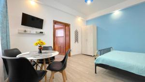 a small room with a table and a bed and a bedroom at EVU Long Street in Braşov