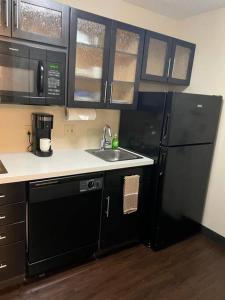 a kitchen with a black refrigerator and a sink at Ultimate Escape/Free Parking in Houston
