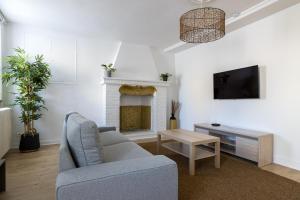 a living room with a couch and a fireplace at L´Oranger in Pougny