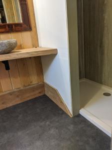 a bathroom with a wooden shelf and a sink at La'al Cabin, tiny home, unique space Eden Valley Cumbria in Brampton