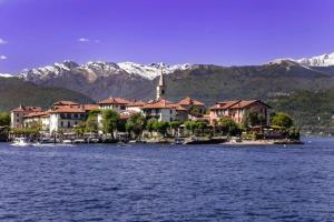 une ville sur l'eau avec des montagnes en arrière-plan dans l'établissement Il Nido su Stresa, à Brovello-Carpugnino