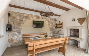 a room with a wooden table and a stone wall at Awesome Home In Sv,petar U Sumi With Kitchen in Sveti Petar u Šumi