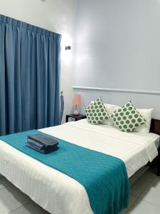 a bedroom with a large bed with blue curtains at Birdcage Boutique in Phnom Penh