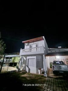 ein weißes Gebäude mit einem davor geparkt in der Unterkunft Departamentos las chacras in Juana Koslay 