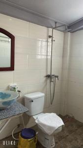 a bathroom with a toilet and a sink at Villa Thavisouk Legend - Luang Prabang in Luang Prabang