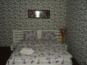 a bed in a bedroom with a black and white wallpaper at Apartment on Vasylia Stusa St, 10 in Bila Tserkva