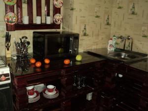 a kitchen with a counter top with a microwave at Apartment on Vasylia Stusa St, 10 in Bila Tserkva