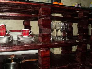 a table with cups and plates and wine glasses at Apartment on Vasylia Stusa St, 10 in Bila Tserkva