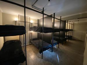 a room with four bunk beds in a room at Urban Jungle Hostel in San Miguel de Tucumán