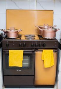 two pots and pans sitting on top of a stove at Forget your worries in this serene 5 Bedroom Villa in Ngong in Nairobi