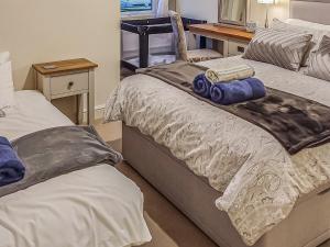 two beds sitting next to each other in a room at Springhill Court in Bewdley