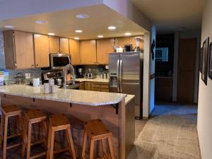 a kitchen with a counter and a refrigerator at Giant Steps 17 Ski In-out in Brian Head